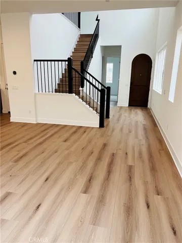 a view of a bedroom with wooden floor