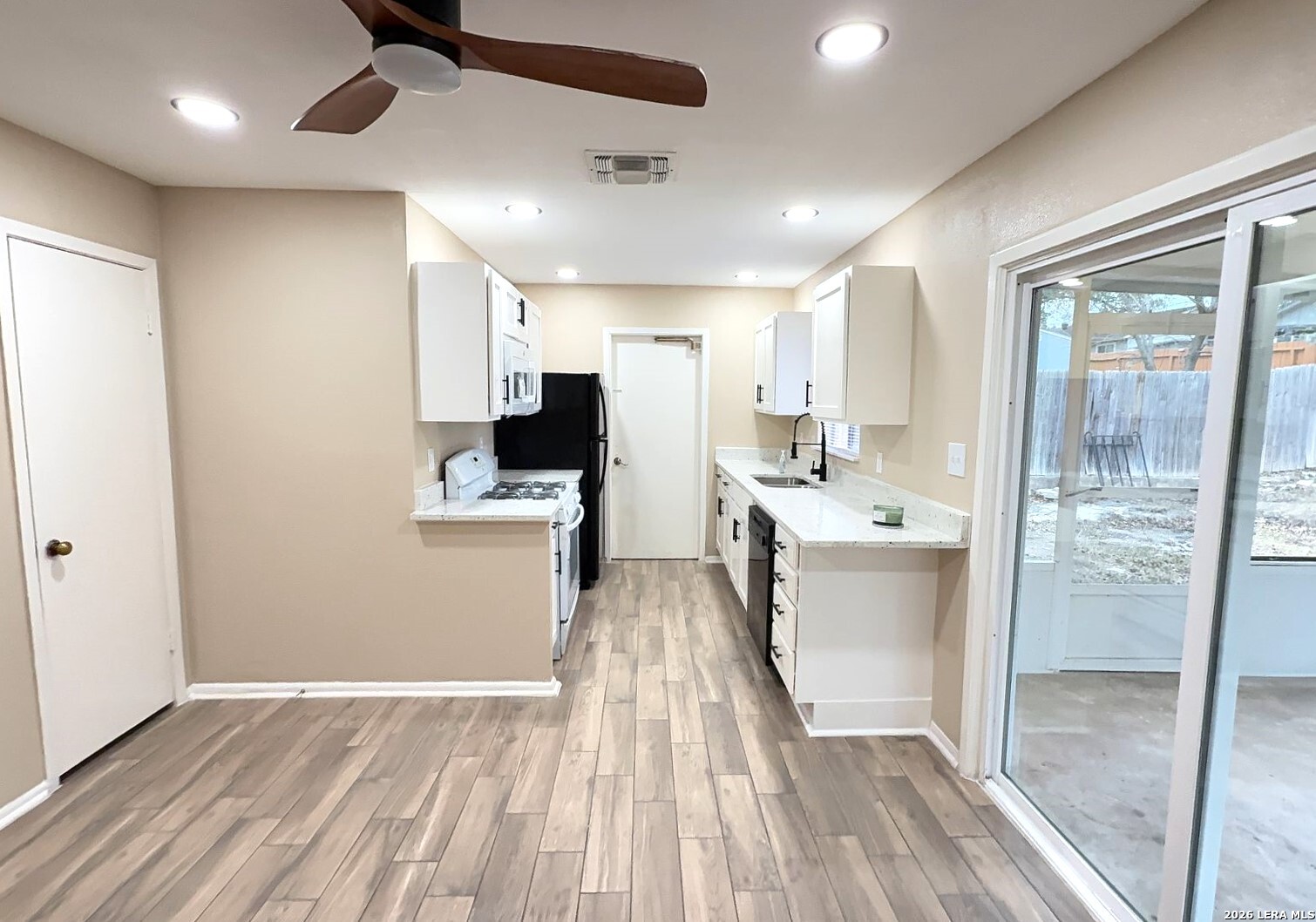 4119 Ramsgate Street San Antonio, TX 78230 - Photo 4 of 14 a kitchen with a sink stainless steel appliances counter space and a window
