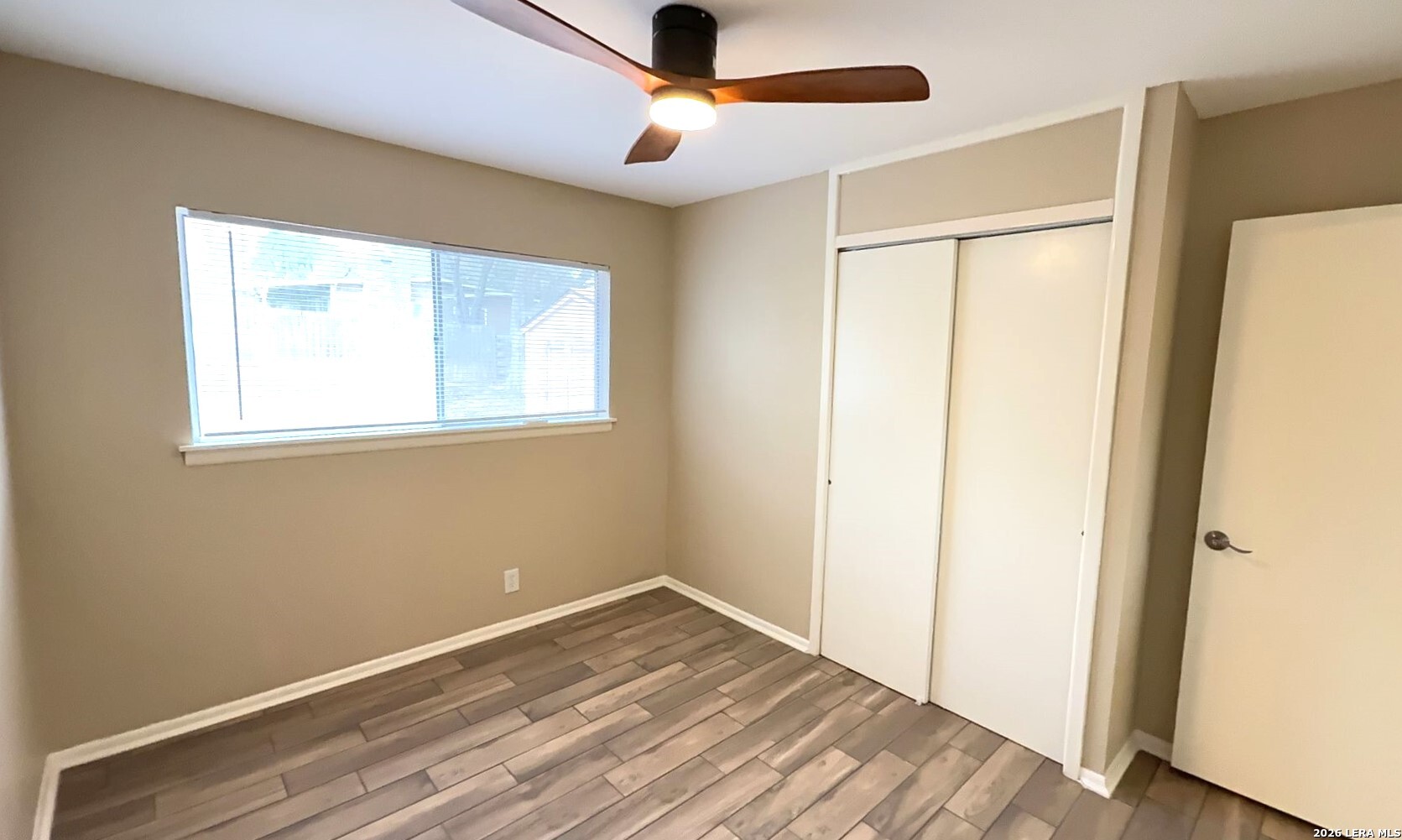 4119 Ramsgate Street San Antonio, TX 78230 - Photo 7 of 14 a view of empty room with wooden floor and fan