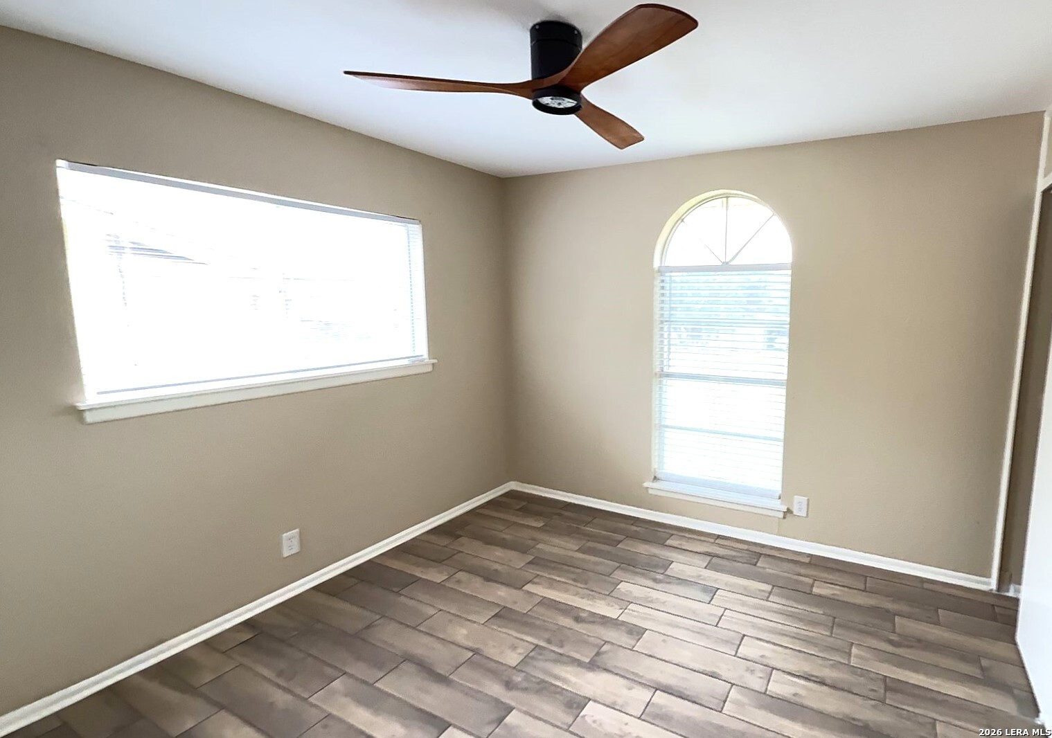 4119 Ramsgate Street San Antonio, TX 78230 - Photo 10 of 14 an empty room with wooden floor fan and windows