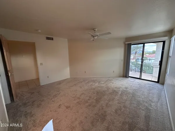 an empty room with windows and closet