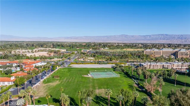 an aerial view of residential houses with outdoor space and trees