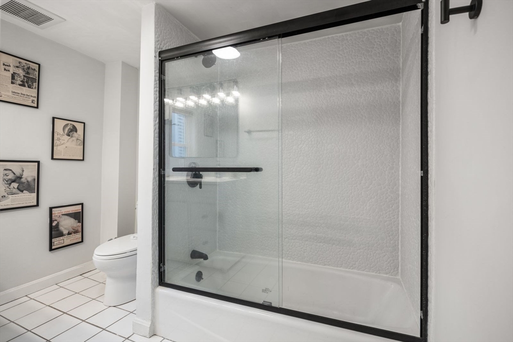 4 Mead St Court Boston, MA 02129 - Photo 13 of 29 a bathroom with a glass shower door