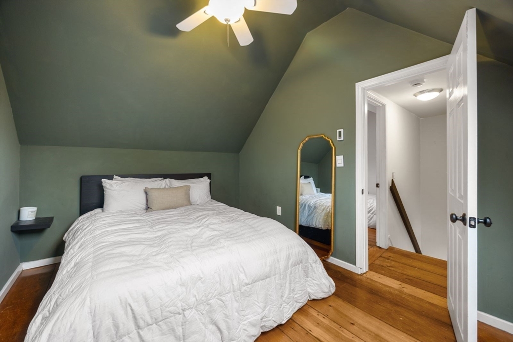 4 Mead St Court Boston, MA 02129 - Photo 16 of 29 a bedroom with a bed and a chandelier