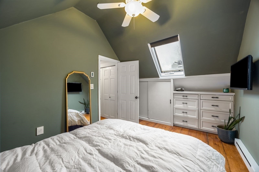 4 Mead St Court Boston, MA 02129 - Photo 18 of 29 a bedroom with a bed and a chandelier