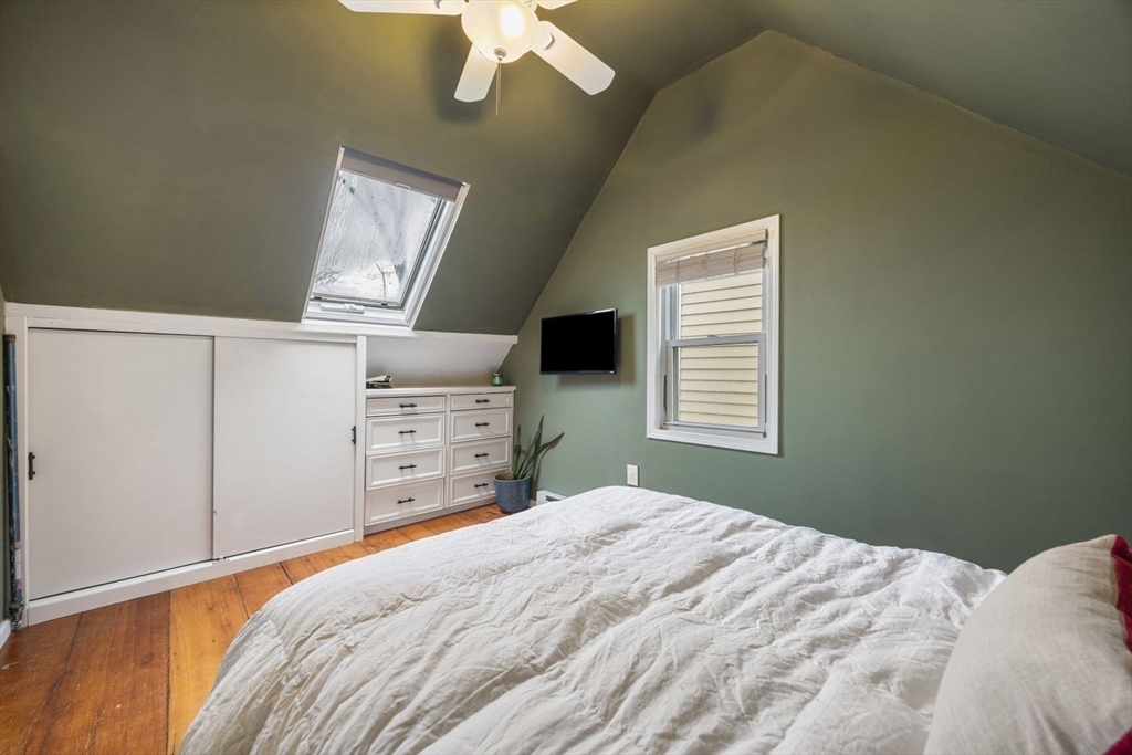 4 Mead St Court Boston, MA 02129 - Photo 19 of 29 a bedroom with a large bed and a tv