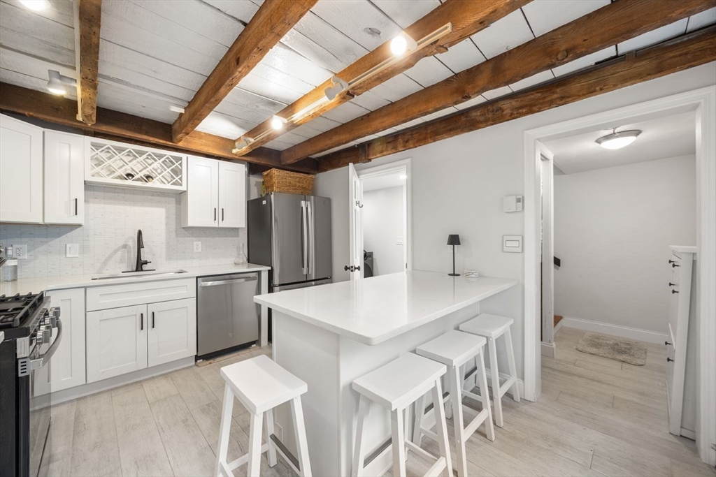 4 Mead St Court Boston, MA 02129 - Photo 2 of 29 a kitchen with sink and white cabinets