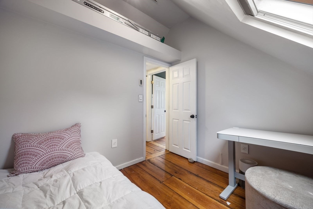 4 Mead St Court Boston, MA 02129 - Photo 21 of 29 a bedroom with a bed and wooden floor
