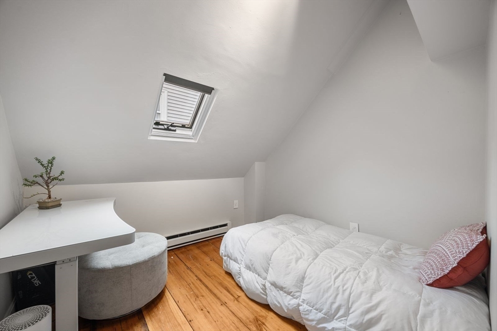 4 Mead St Court Boston, MA 02129 - Photo 22 of 29 a bedroom with a bed and a table