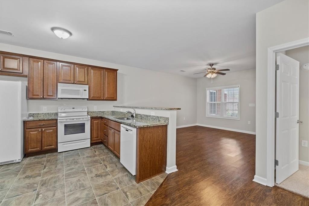 150 Old Mill Road, Unit 435 Cartersville, GA 30120 - Photo 11 of 22 a kitchen with stainless steel appliances granite countertop a stove top oven sink and cabinets