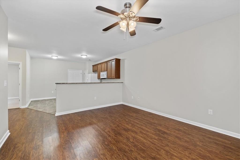 150 Old Mill Road, Unit 435 Cartersville, GA 30120 - Photo 7 of 22 a view of a kitchen with wooden floor and a ceiling fan