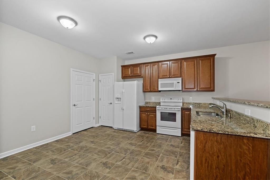 150 Old Mill Road, Unit 435 Cartersville, GA 30120 - Photo 10 of 22 a kitchen with stainless steel appliances granite countertop a stove sink and cabinets