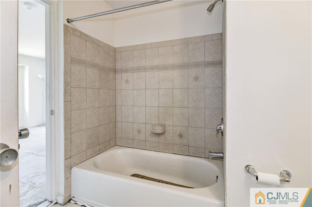 1131 Edpas Road, Unit 1131 New Brunswick, NJ 08901 - Photo 13 of 20 a bath tub sitting next to a white sink and vanity