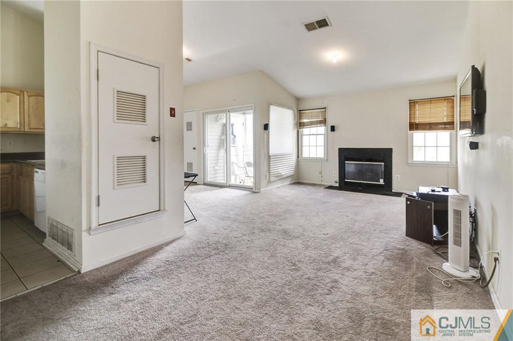 1131 Edpas Road, Unit 1131 New Brunswick, NJ 08901 - Photo 3 of 20 a view of livingroom with furniture flat screen tv and refrigerator
