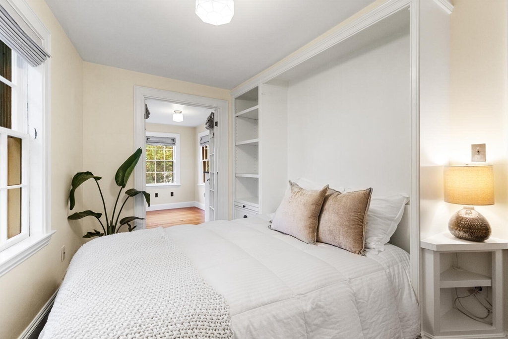 33 Waldron Street Marblehead, MA 01945 - Photo 27 of 42 a bedroom with a bed a mirror and table