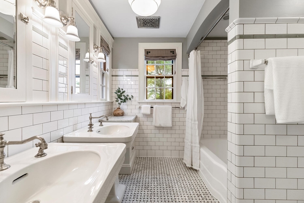 33 Waldron Street Marblehead, MA 01945 - Photo 30 of 42 a bathroom with a sink a toilet a mirror and shower