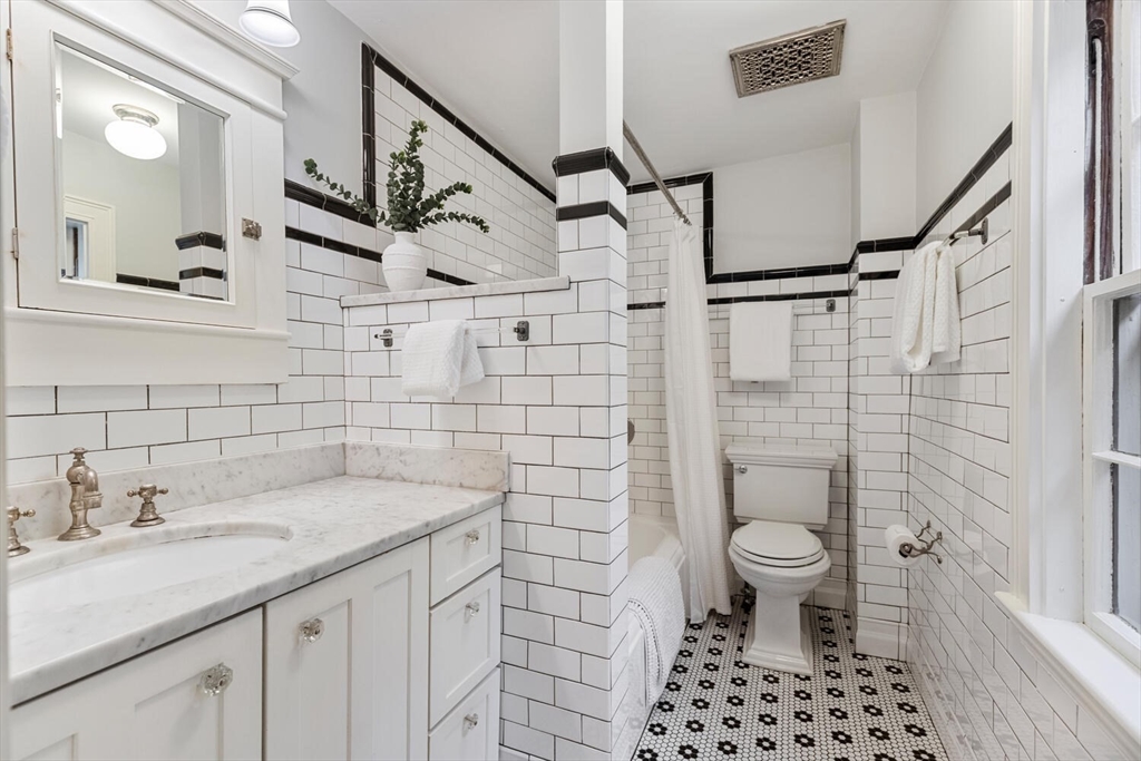 33 Waldron Street Marblehead, MA 01945 - Photo 31 of 42 a bathroom with a sink a toilet and shower