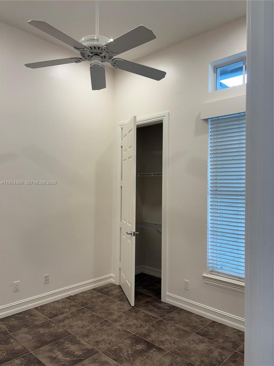 18265 Southeast Ridgeview Drive Tequesta, FL 33469 - Photo 9 of 15 an empty room with an entryway and chandelier fan