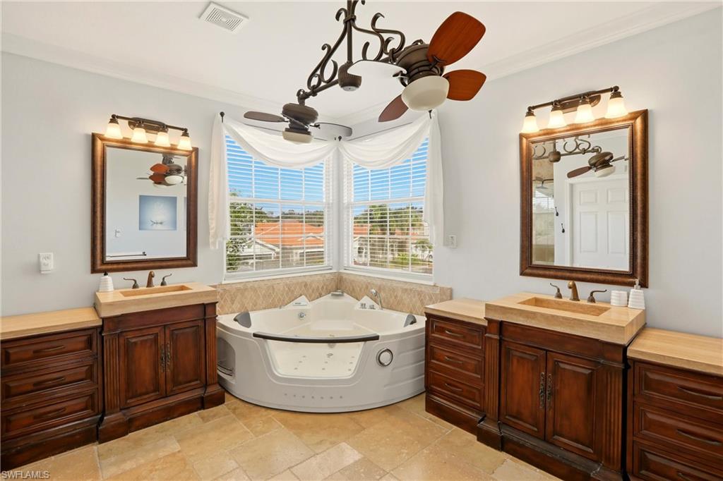 2150 Khasia Point Naples, FL 34119 - Photo 17 of 42 a bathroom with a tub sink and mirror