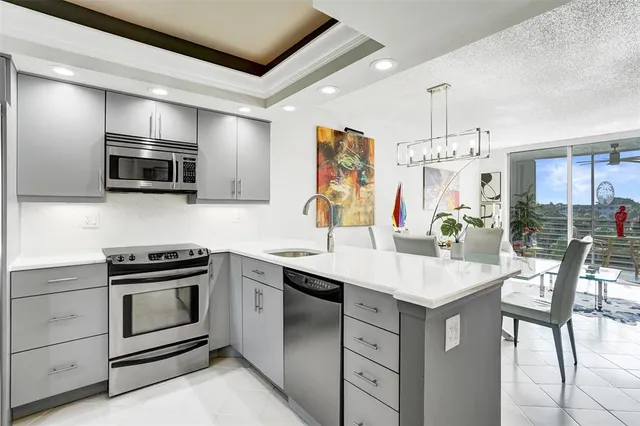 a kitchen with a sink stove and microwave