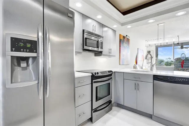 a kitchen with stainless steel appliances granite countertop a refrigerator and a sink