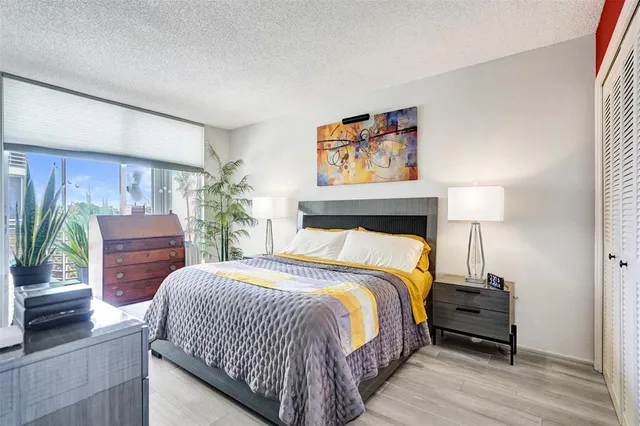 a bedroom with a bed and a potted plant