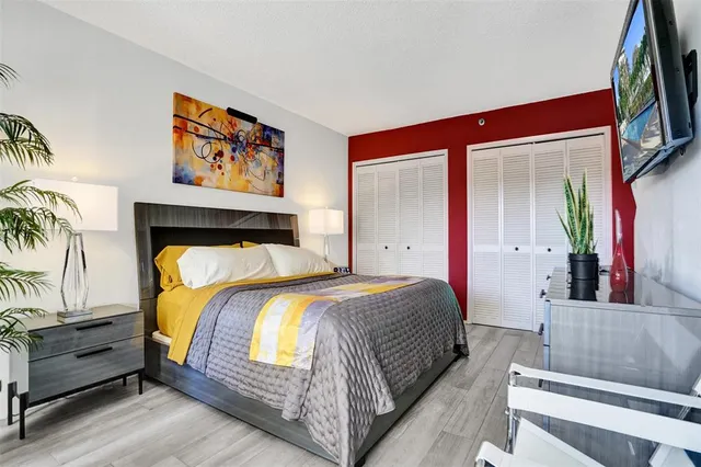 a bedroom with a bed and a painting on the wall