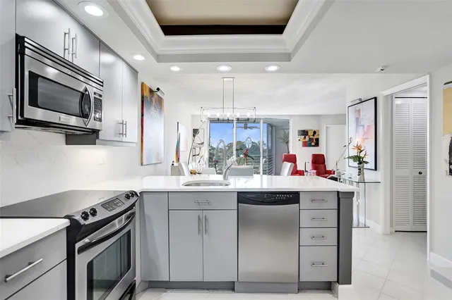 a kitchen with a sink stove and microwave