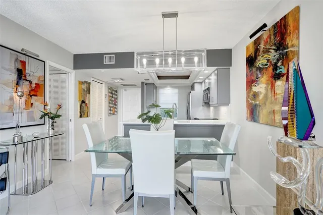 a view of a dining room with furniture and a chandelier