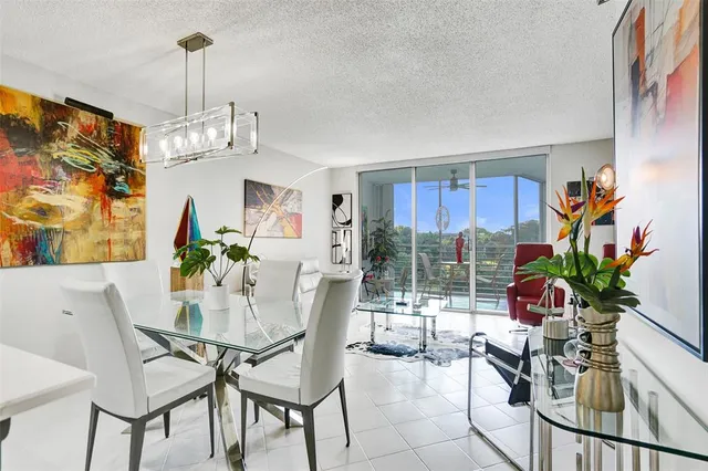 a view of a dining room with furniture a livingroom and chandelier