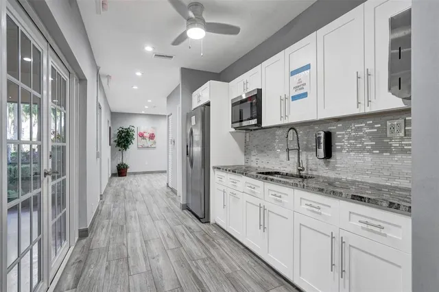 a kitchen with cabinets a sink and appliances
