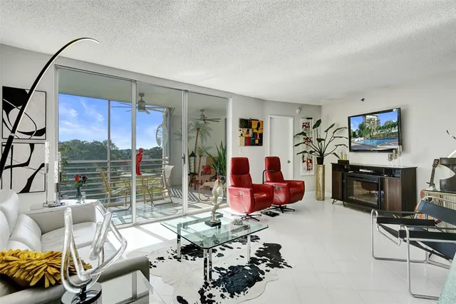 a living room with furniture gym equipment and a floor to ceiling window