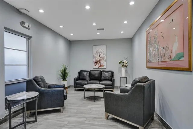 a living room with furniture and a potted plant