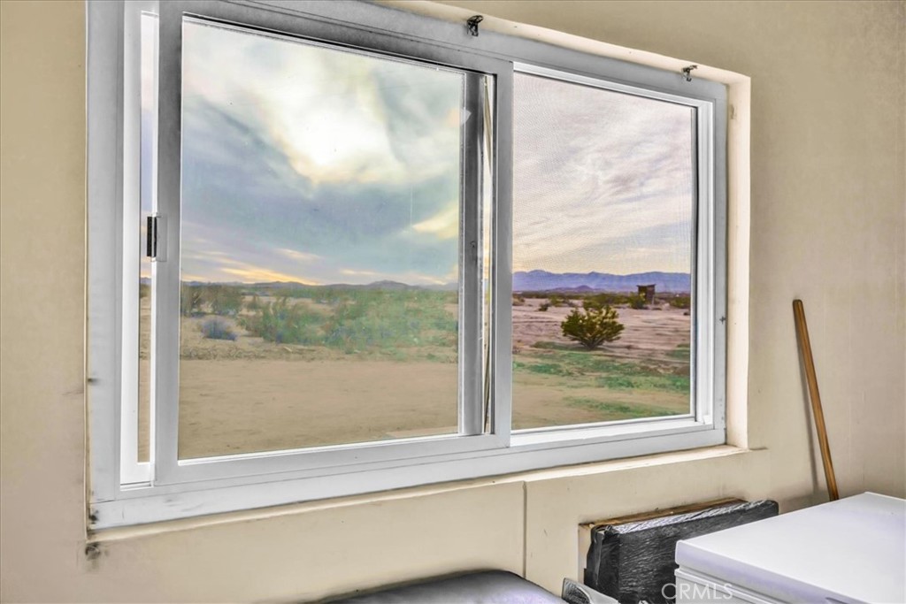 67550 Del Oro Road Twentynine Palms, CA 92277 - Photo 11 of 41 a view of a bathroom with a glass door and a window