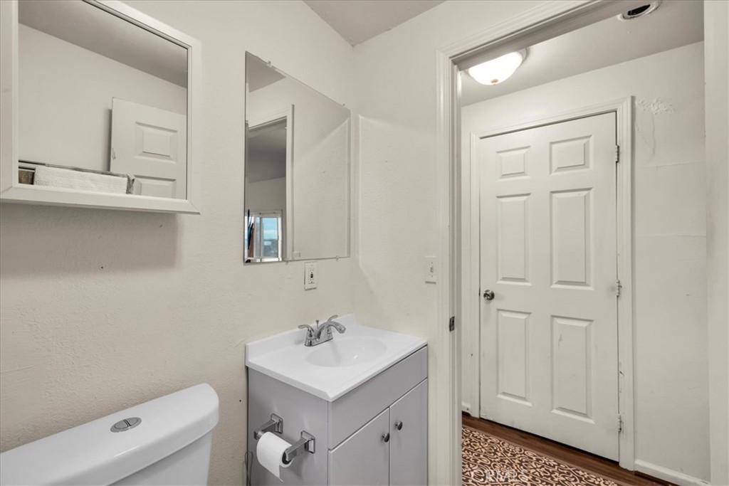 67550 Del Oro Road Twentynine Palms, CA 92277 - Photo 18 of 41 a bathroom with a sink a toilet and vanity