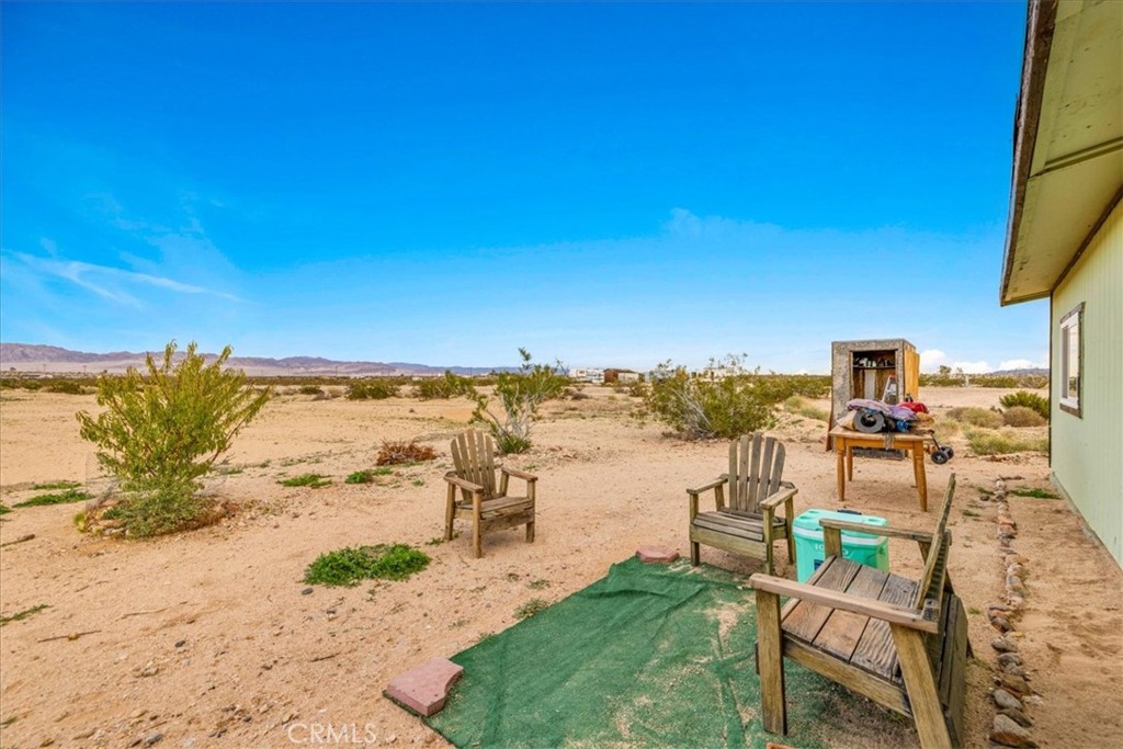 67550 Del Oro Road Twentynine Palms, CA 92277 - Photo 24 of 41 a view of a lake with table and chairs