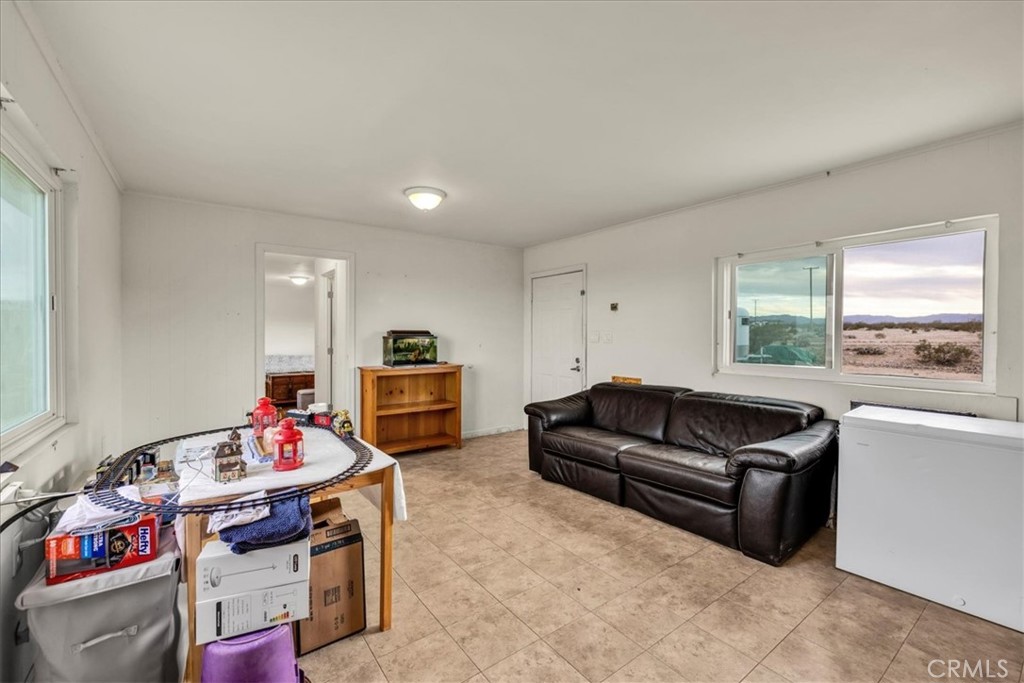67550 Del Oro Road Twentynine Palms, CA 92277 - Photo 9 of 41 a living room with furniture fireplace and a window