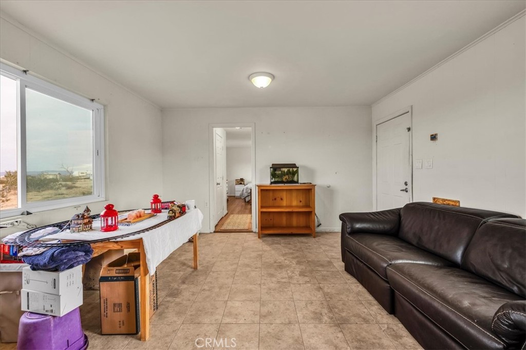 67550 Del Oro Road Twentynine Palms, CA 92277 - Photo 10 of 41 a living room with furniture and a table