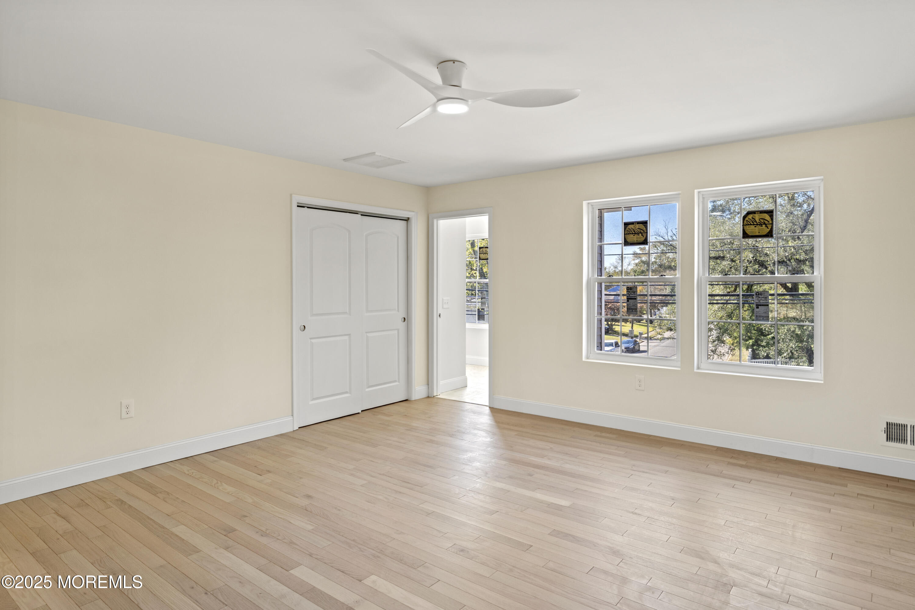 636 Wayside Road Neptune Township, NJ 07753 - Photo 11 of 26 an empty room with wooden floor and windows