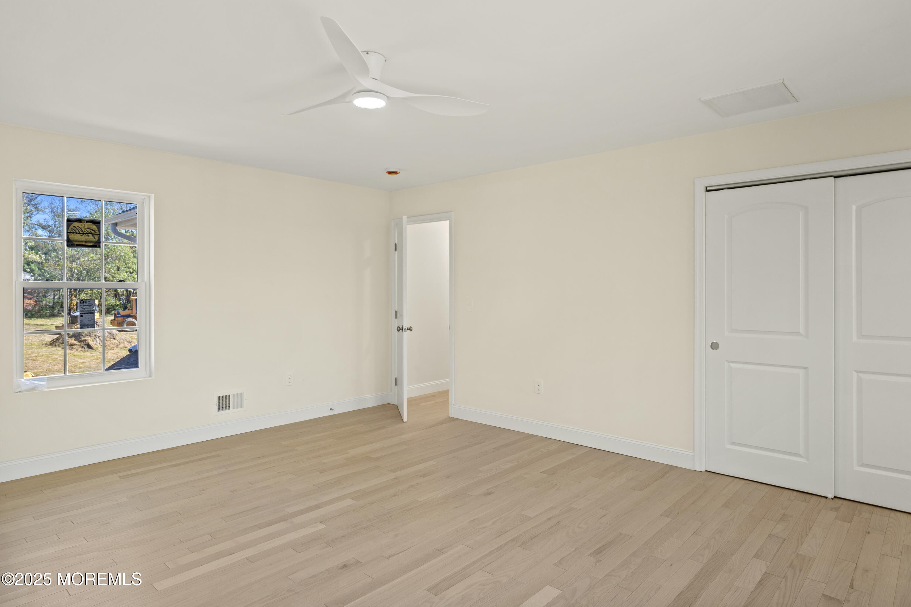 636 Wayside Road Neptune Township, NJ 07753 - Photo 12 of 26 wooden floor in an empty room with a window