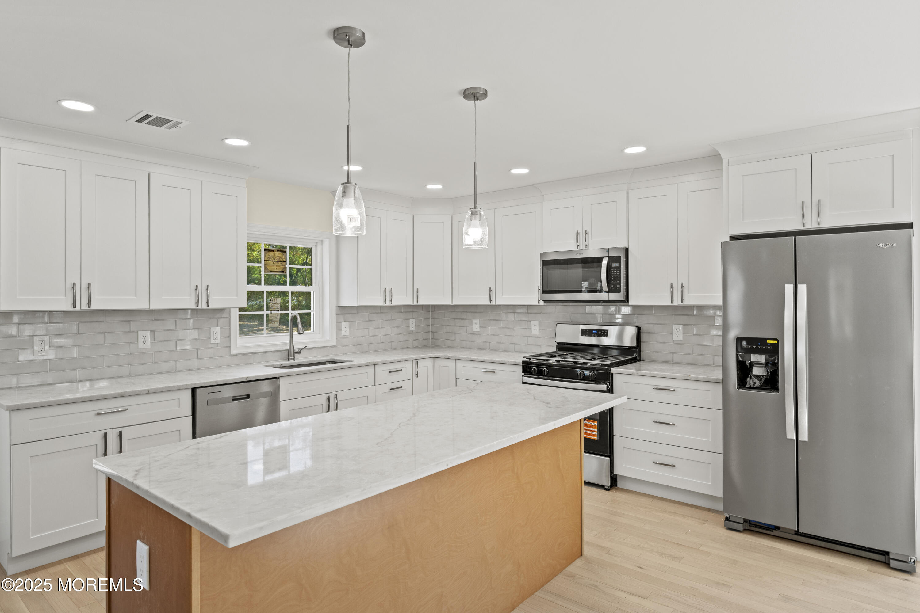636 Wayside Road Neptune Township, NJ 07753 - Photo 4 of 26 a kitchen with stainless steel appliances granite countertop a sink a stove a refrigerator and island with wooden floor