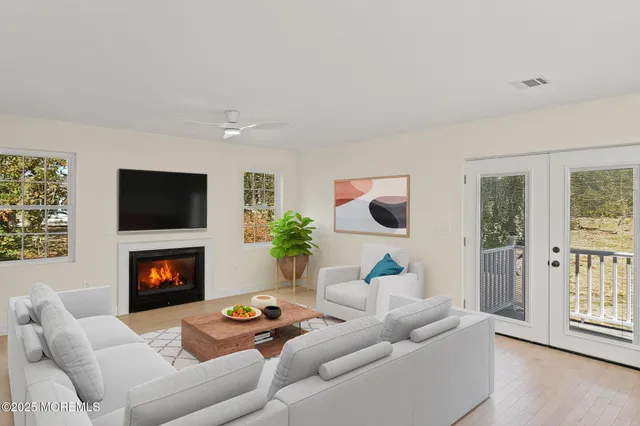 a kitchen with stainless steel appliances granite countertop a sink a stove and a wooden floors