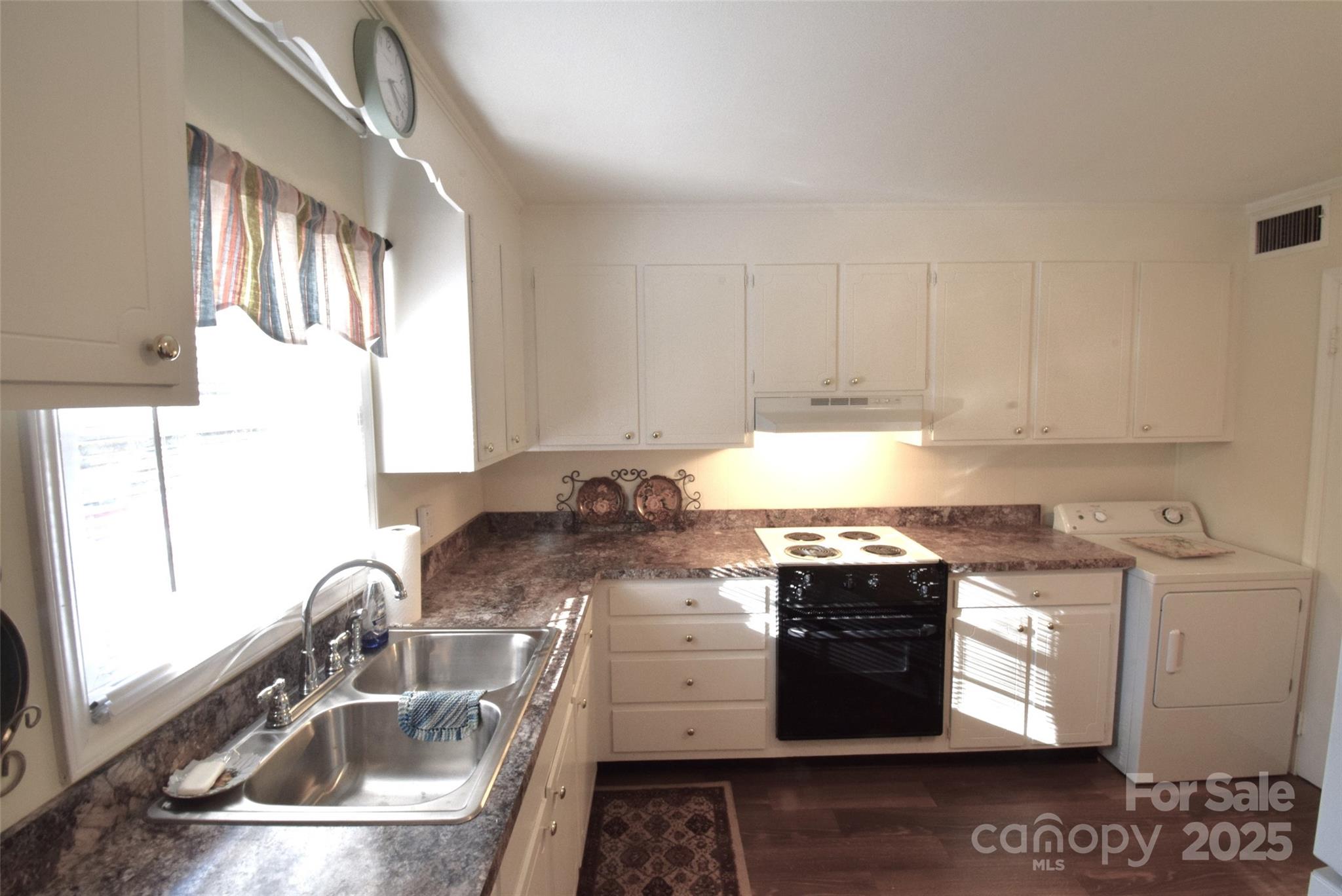 623 South New Hope Road, Unit 13 Gastonia, NC 28054 - Photo 11 of 30 a kitchen with granite countertop a sink stove and cabinets