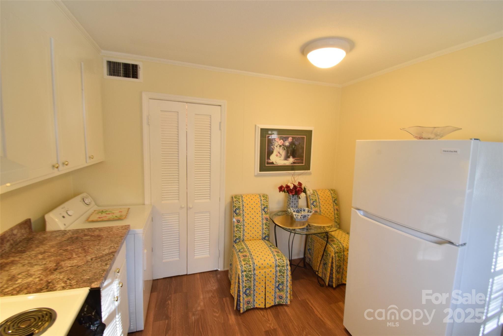 623 South New Hope Road, Unit 13 Gastonia, NC 28054 - Photo 12 of 30 a room with a refrigerator and a wooden floor