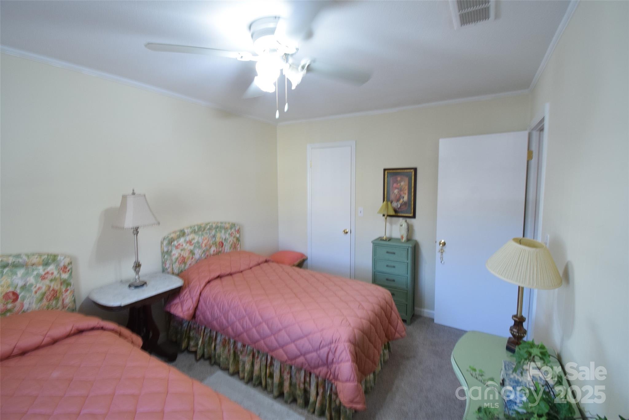 623 South New Hope Road, Unit 13 Gastonia, NC 28054 - Photo 20 of 30 a bedroom with two beds and a chandelier