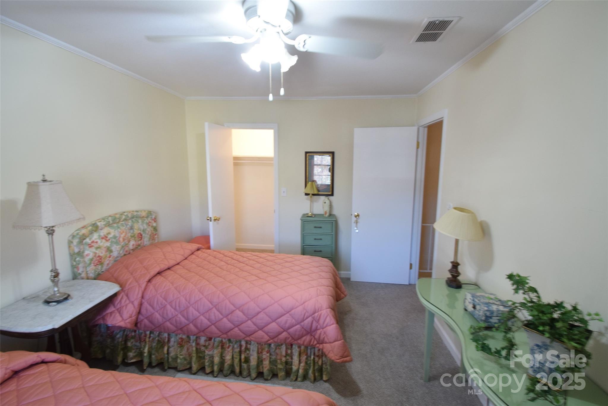 623 South New Hope Road, Unit 13 Gastonia, NC 28054 - Photo 21 of 30 a bedroom with a bed chandelier and a window
