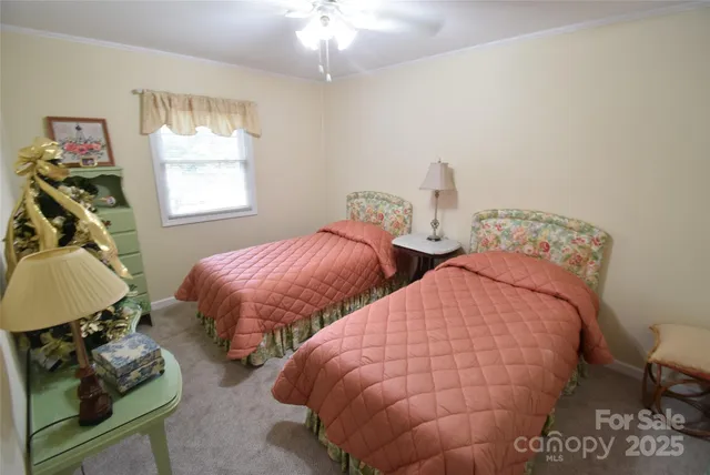 a bedroom with two beds and a window