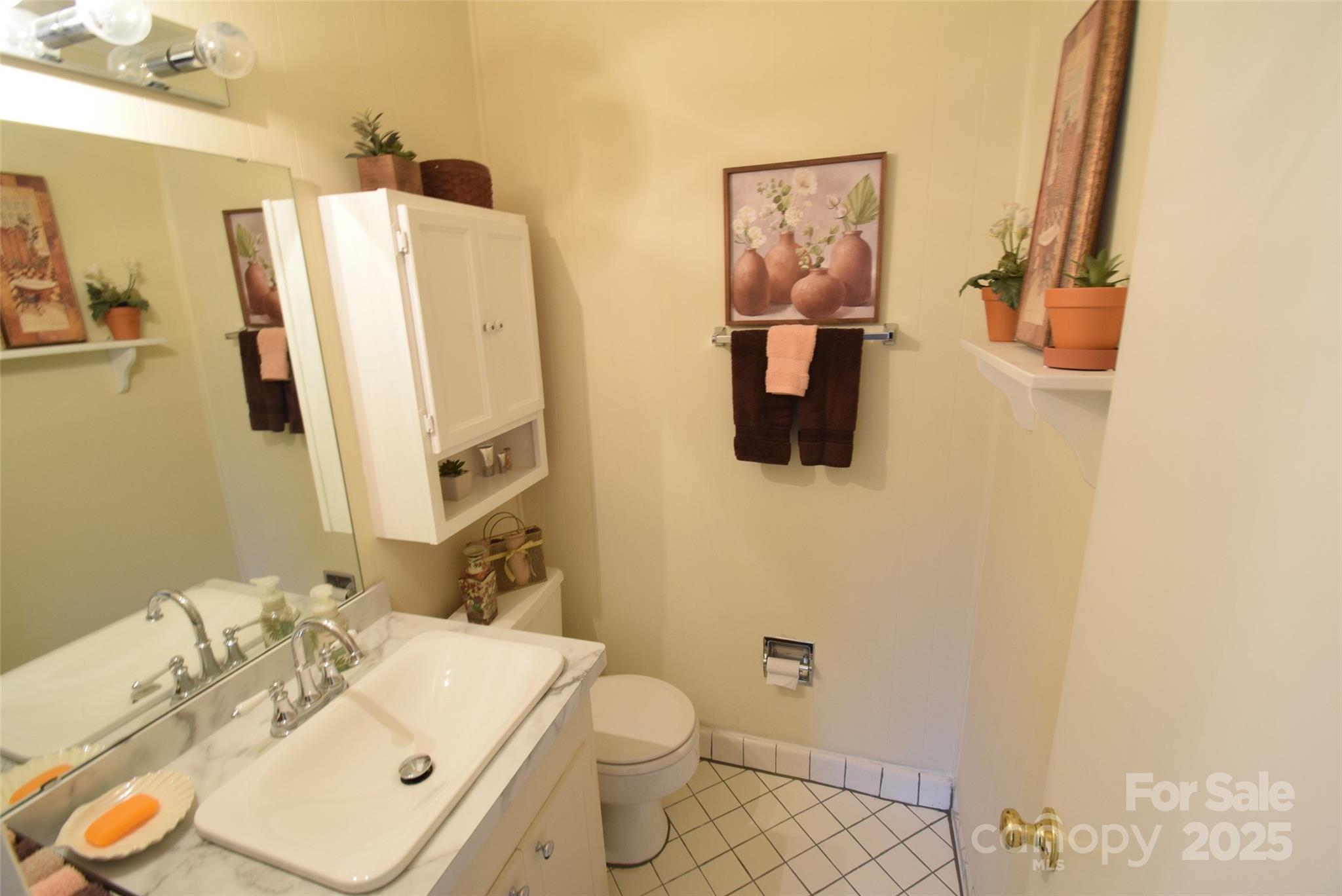 623 South New Hope Road, Unit 13 Gastonia, NC 28054 - Photo 30 of 30 a bathroom with a sink toilet and mirror
