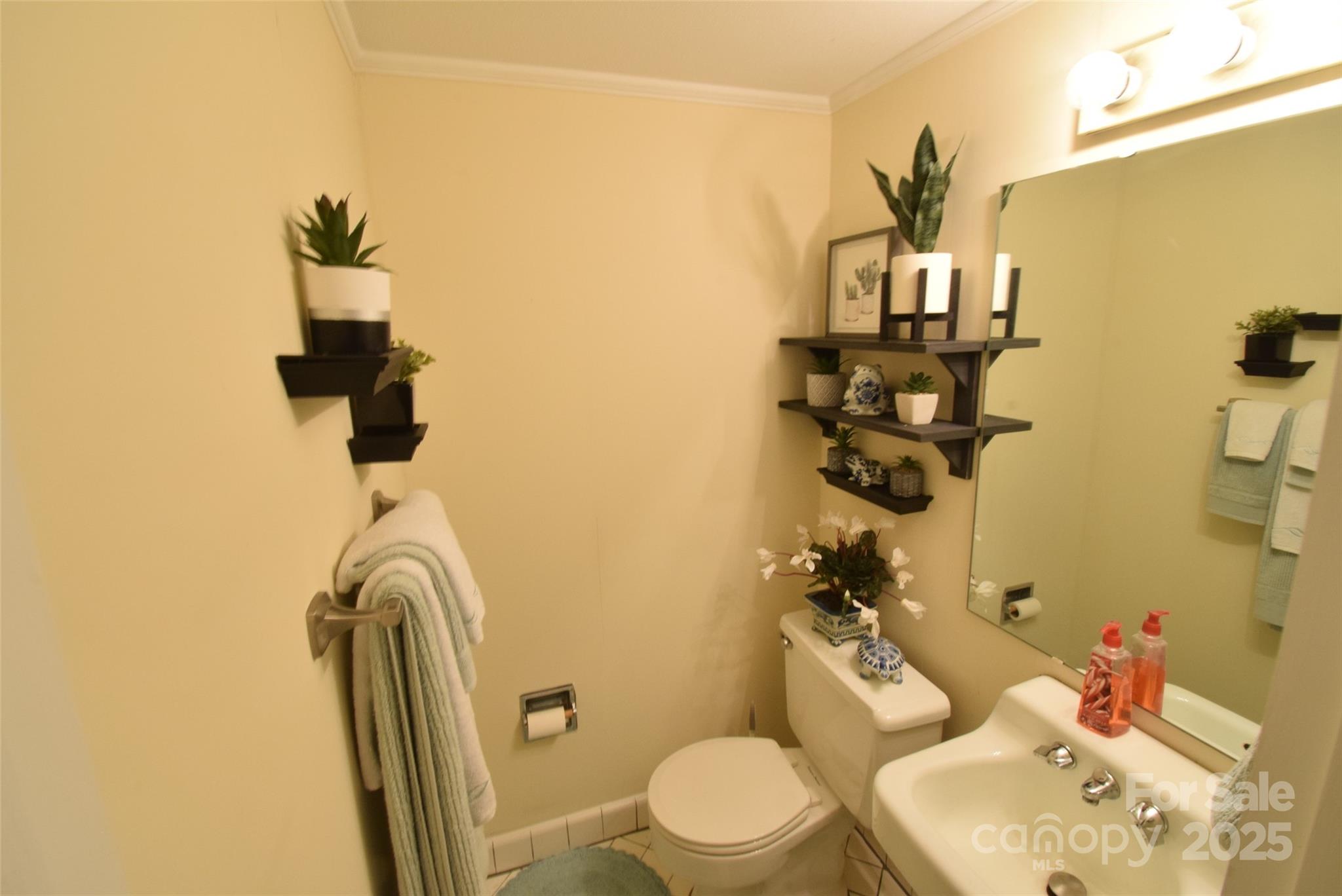 623 South New Hope Road, Unit 13 Gastonia, NC 28054 - Photo 9 of 30 a bathroom with a toilet sink and mirror
