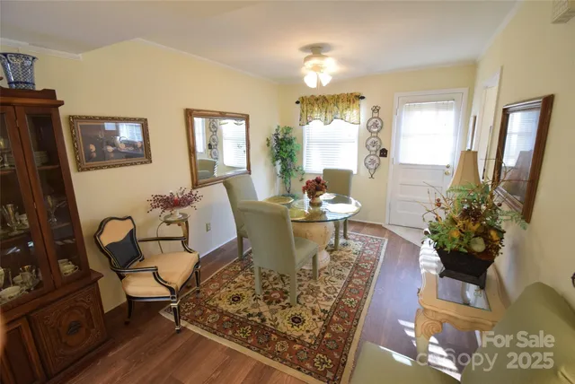 a room with a refrigerator and a wooden floor